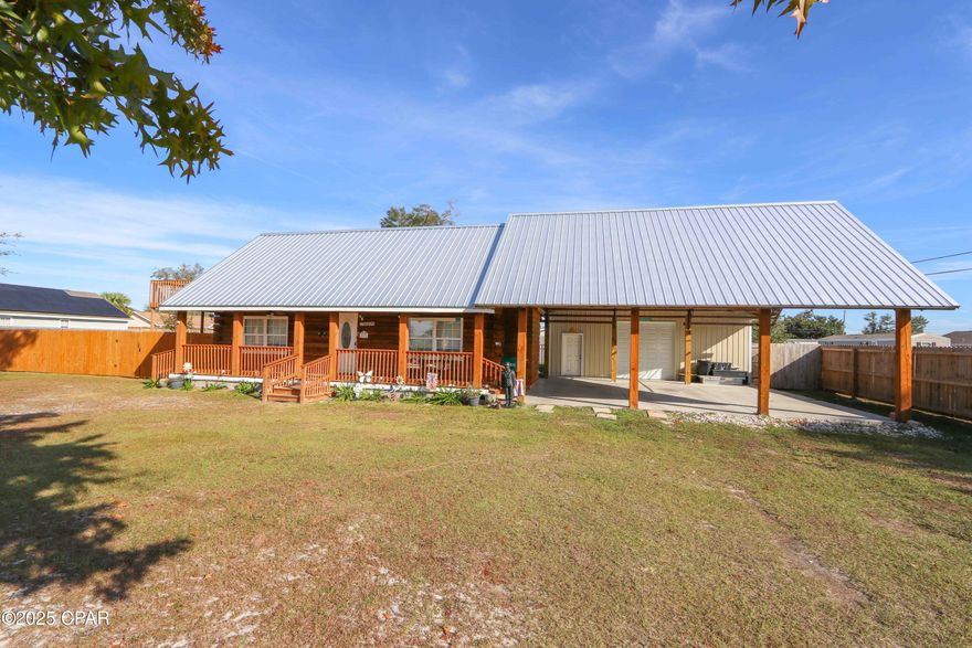 $20k Recent Price Reduction! Step back in time with this solid but charming 2-story log cabin on a rare .378-acre double lot in Callaway. From the oversized ''old west'' style front porch to the 2 separate entrances, this home consists of 2 bedrooms downstairs and the loft upstairs is currently set up as a bedroom as it has a half bath. This home is unique, and packed with big upgrades. Over $100K in improvements over the past 2 years include a new metal roof, full crawl space encapsulation with perimeter seal and dehumidifier, fresh exterior stain and sealant making the home tight and energy efficient, plus all-new fencing around the entire yard and much more you have to see for yourself.  A brand-new 3-vehicle carport connects to a metal building with 4 roll-up doors and top-of-the-line smart openers—perfect for a workshop, storage, or all your toys. There's also a new RV electrical hookup. The extra lot already has power run for a future home, giving you the option to build new and use the cabin as a cozy short-term rental. Less than ½ mile down the same street is a boat ramp they used for quick fishing trips. When asked what they'll miss most, the sellers said ''the neighbors.'' This street still feels like an old-school, tight-knit community where people look out for each other, borrow a cup of sugar, and don't hesitate to help when you need a hand. Located in an up-and-coming area of Bay County, close to Tyndall AFB.