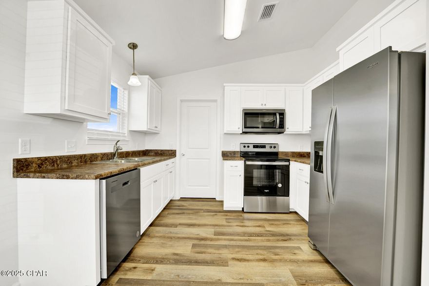 CURRENTLY UNDER CONTRACT, SELLER WILL CONSIDER BACKUP OFFERS Welcome to this freshly painted move-in ready, single-story home offering modern comfort and style. Built in 2023, this charming property features 3 bedrooms and 2 bathrooms with durable LVP flooring throughout. The bright, open-concept kitchen is equipped with stainless steel appliances, including a refrigerator, dishwasher, and electric range. Enjoy central heating and air conditioning, convenient washer/dryer hook-ups, and a private yard perfect for relaxing or entertaining. Parking for multiple cars available. All measurements are approximate and taken from public records, buyer to verify any details buyer deems important.