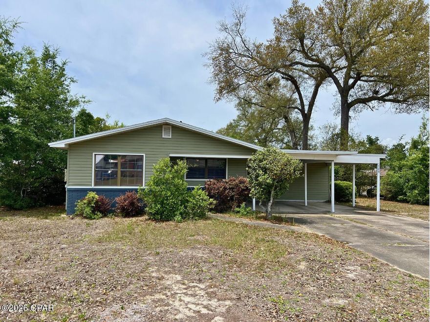 Welcome to this well-located 3-bedroom, 2-bath home situated on a desirable corner lot in a quiet, established neighborhood. Inside, the living room features a built-in bookcase that adds both character and functionality, creating a warm and inviting space to relax or entertain. The layout offers comfortable everyday living with plenty of potential to make it your own. One of the standout features of this home is the solar panels which will be fully paid off at closing, giving you the benefit of energy efficiency without the added expense. The attached 2-car carport provides convenient covered parking, along with a closed-in laundry and storage area at the rear, offering extra space for organization and practicality. Location is key, and this home delivers. You are just a short distance to schools, churches, and shopping, while still enjoying the feel of a peaceful neighborhood. Outdoor lovers will appreciate being within walking distance to Parker Environmental Exploratorium Park, a local favorite for nature trails and exploring. If you are looking for a home that combines comfort, convenience, and everyday functionality in Panama City, this one is worth a closer look. Dimensions approximate, please verify if important.