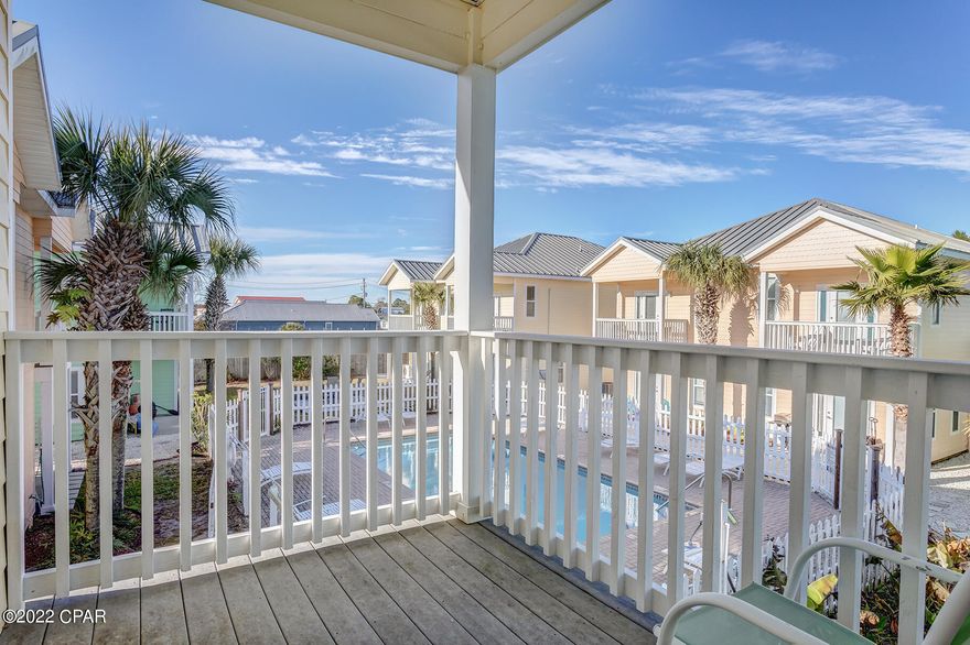 CURRENTLY UNDER CONTRACT, SELLER ACCEPTING BACKUP OFFERS.  Perfect turn-key home, second home, or rental.  Absolutely gorgeous, gulf view duplex townhome with 11 foot ceilings, huge living spaces, custom wide-plank wood floors, upgraded tile, new carpet, designer ceiling fans, and a great kitchen with a huge pantry.  The kitchen boasts gorgeous custom cabinets, Corian countertops and a long breakfast bar.  Both bedrooms have private baths and entrances, walk-in closets, a large master shower, and washer/dryer. Watch the kids in the pool while you grill on the back balcony.  Walk across the street to the beach!  Or watch the sunset from the front  balcony.  Furnished with some exclusions.  Outstanding location and super-low quarterlies.