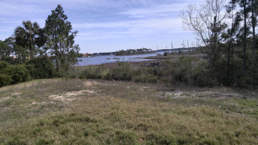 Waterfront lot overlooking Grand Lagoon. No flood insurance is required for this lot in Flood Zone X. Located inside the gated community of Bay Point that boasts two championship golf courses, Club 19, a full service spa ''Serenity'', a deep water marina with boat ramp gives easy access to Shell Island and the Gulf of Mexico, multiple restaurants, children's playground and tennis courts. Come take a look at this large cleared lot with views of Grand Lagoon.(Please verify new buyers fee and HOA fees) SOME FEES APPLY FOE SOME AMMENTIES (GOLF,TENNIS,MARINA) USE. Annual Waterfront and Canal Assoc. fee of $250
