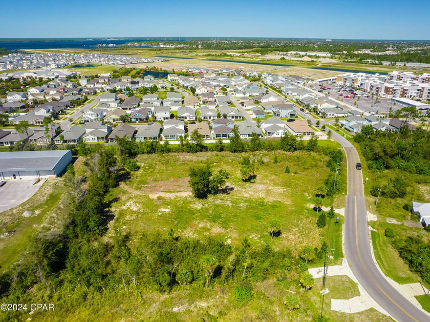 Don't miss this opportunity. Discover an exceptional investment opportunity with this 2.12-acre commercial lot, ideally situated adjacent to the 700-acre Sweetbay master-planned community. Boasting easy access to the newly improved Highway 390, this flat parcel is free from wetlands and easements, ensuring straightforward development.  This lot offers versatile possibilities, including the potential for office spaces or other commercial uses. Can fit a 10,000 sq ft commercial building or a multi story storage complex. Positioned close to the emerging Sweetbay town center, a brand new Publix supermarket, and a future marina, this property benefits from the area's rapid growth and increasing demand. A gas station conveniently located across the street further enhances its appeal. Originally zoned residential, the property has been meticulously rezoned for commercial use GC-2, highlighting its prime suitability for high-yield investment ventures. With the ongoing development in Sweetbay, this lot promises substantial income opportunities and a strategic foothold in a flourishing community. Topo and geographic surveys are available upon request.