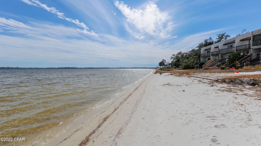 CURRENTLY UNDER CONTRACT SELLER Will Consider BACK UP OFFERS. If having your own Beach at the foot of your oversized deck sounds good than this home is waiting for you. Hidden on East Bay there is a quaint little community . just before you cross the bridge to Tyndall AFB directly on the Water with large decks.  This renovated and updated 3 bed 2.5 bath townhouse with 1 car Garage will WOW you with the breathtaking views of open water on the Bay. Huge Deck off the living room. This community allows long-term rentals.  Easy to rent these if you are buying as an investment and lots of room for storing your kayaks or jet skis under the deck These units go quickly, boat ramp and park.  Last one sold for 275k without all the same upgrades. Easy to show and Unit will be vacated by end of July.