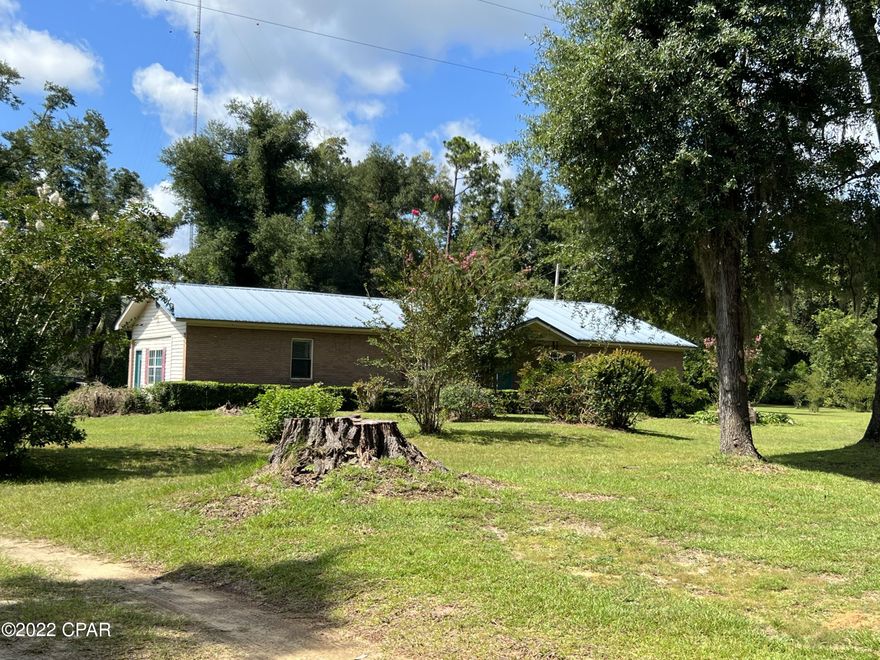 Escape to the PEACE & QUIET Country living on 2 acres in a 4/2 1/2 bath brick home.  Home does need some work but has a load of potential.  Metal roof, laundry room, huge master bedroom, as well as  M/Bath and closet. Office space, Kitchen with SS appliances.  This place is priced to sell.  Beautiful yard with lots of fruit tree's and plants.  Priced to sell.