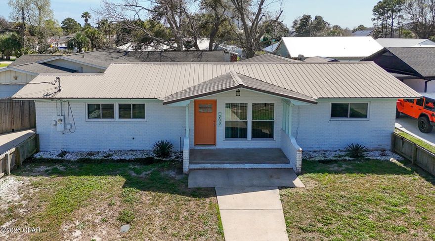 Perfectly located in the Open Sands community of Panama City Beach, this 3-bedroom, 2-bath home offers a walk-to-the-beach lifestyle, golf cart friendly neighborhood, and convenient access to Pier Park just one mile away.  The home features recently installed hurricane-rated impact windows, providing added storm protection, energy efficiency, and potential insurance benefits. Remodeled kitchen with quartz countertops, updated cabinetry, and modern finishes. Tile flooring throughout. Enjoy the convenience of beachside living with shopping, dining, and entertainment just minutes away.