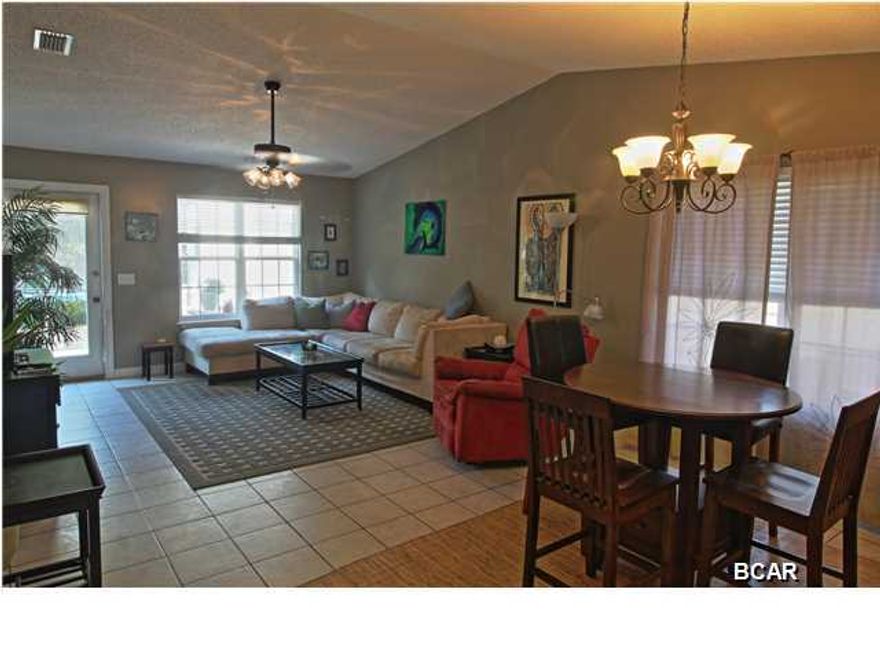 Great value in this home which is located in the desirable Riviera Beach subdivision on the west end of Panama City Beach. Quiet, family oriented golf cart community with no association fees. Perfect location just a short stroll to the beach, minutes to the boutiques and restaurants on scenic 30A and in Pier Park, one mile to Lake Powell, and convenient to Frank Brown and the airport. No wasted space in this split bedroom floor plan with a large vaulted great room. Ample storage in the kitchen with mosaic glass tile backsplash, Kohler sink, breakfast bar, Whirlpool appliances and new stainless Samsung microwave vent hood. Oversized Master bedroom suite includes a walk in closet. Neutral tile throughout, three panel doors, updated ceiling fans and light fixtures, blinds, and a large laundry room. Outside features include architectural shingles, termite bond, a fully fenced backyard with a drive gate, and a 16 X 20 storage building with a garage door and ramp for golf cart parking. Enclosed outdoor shower with hot and cold water off the back patio. Suitable for permanent residence, second home, or beach vacation rental.