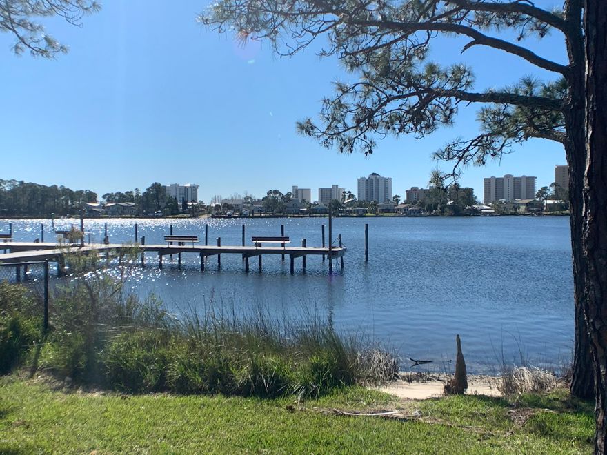 WATERFRONT condo on beautiful Grand Lagoon.  Boat slips right outside your ground floor unit.  Although there is a wait list for the slips, once it is yours the cost is ONLY $500 per year.  This unit has upgraded kitchen and bath with wood cabinets, large tile floors and washer/dryer. The open layout allows beautiful views of the Lagoon form kitchen/dining and living room.  This complex includes a private tennis court and pool.  Owner has only used for personal use on weekends.  This is great LAGOON FRONT LIVING at it's best.  New roof 12/18.  New exterior paint 12/19.  Parking lot to be repaved per HOA. New dock just finished. Pool has been resurfaced in the last few years. Enjoy sunsets from your patio or relax under the gazebo. Grills throughout the complex.  Owners are allowed to have pets.   Seller to offer home warranty.