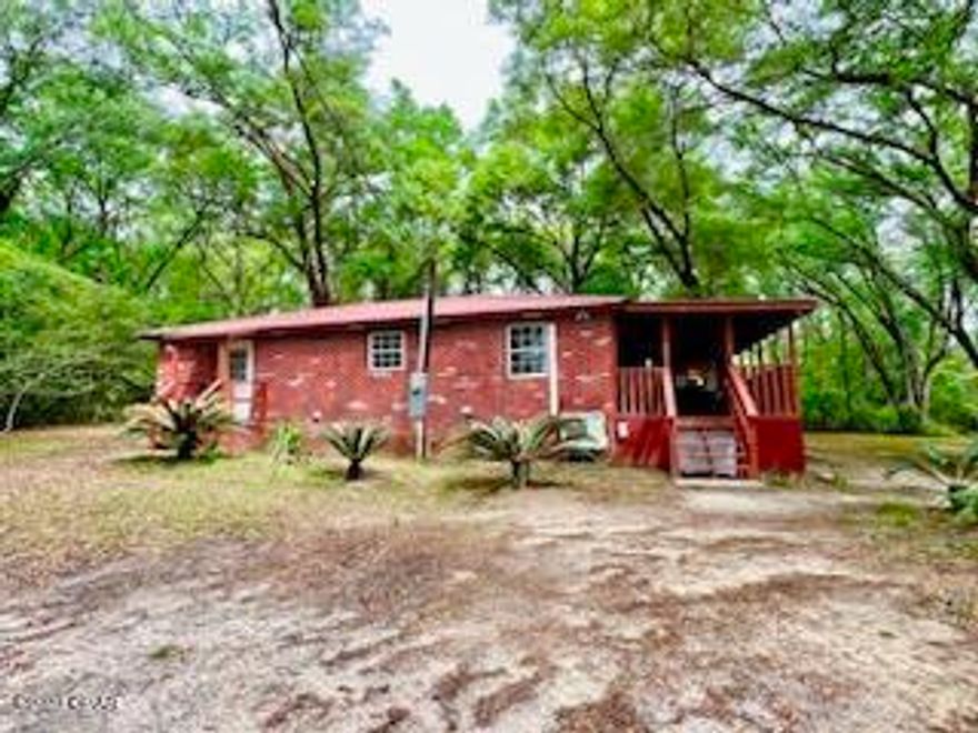 REDUCED! Home in peaceful setting with elbow room on 2 acres. Detached garage is 33x23 and has a new roll up door with plenty of space for a workshop. The home has stucco exteriormade to look like bricks. Roof is red metal. Home has been recently completely renovated. Upgrades include new floor covering, new countertops and refinished cabinets, refinished sheetrock, paint, new HVAC and duct work.  Relax and enjoy the hot tub just off the master bedroom. Kitchen has plenty of cabinet and counter space. Stove, fridge, microwave, washer/dryer stay. Large, covered deck at the side entrance. Many large oak trees in the yard.