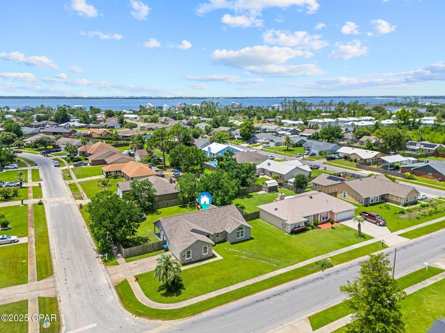 CURRENTLY UNDER CONTRACT, SELLER WILL CONSIDER BACKUP OFFERS. This stunning 3-bedroom, 2-bath, 2-car garage home is on a spacious corner lot and has been fully renovated in the recent years - feels like new from top to bottom! Enjoy peace of mind with major upgrades already completed—including a newer roof (2020), HVAC system AND ductwork (2021), water heater (2021), windows (2021), stainless steel appliances (2021), and flooring (2023) throughout the home. Step inside to a spacious open-concept layout featuring a bright living area with vaulted ceilings, dedicated oversized dining space that can fit your table with the leaf, and a show-stopping kitchen with quartz countertops, updated cabinetry, and a large island. The oversized primary suite boasts a double vanity, walk-in closet, and modern finishes. The other two bedrooms are generously sized with spacious closets, and one has a beautiful arched window allowing for ample natural light. Outside, you'll find an open deck, covered patio area, and a fully fenced backyard. Located just minutes from Tyndall Air Force Base in a NO HOA neighborhood with sidewalks and underground utilities, this move-in ready home blends comfort, convenience, and modern style—don't miss your chance to make it yours! Effective year built is 2019 because of all the updates. All information deemed reliable but buyer to verify if important.