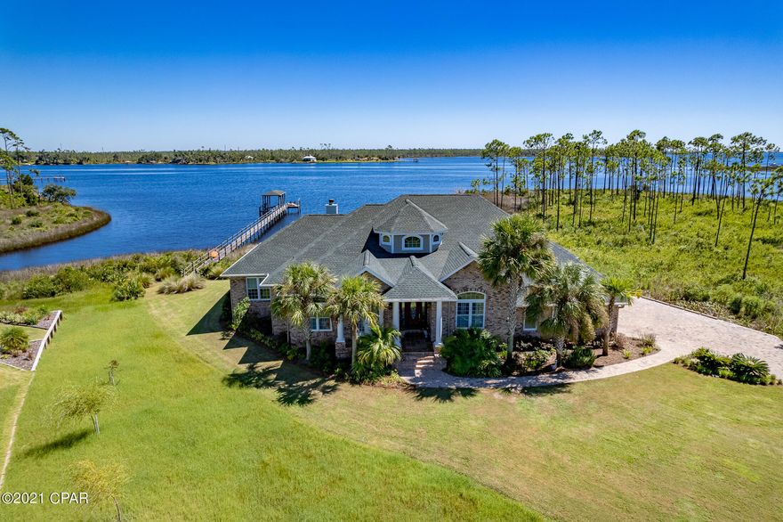 CURRENTLY UNDER CONTRACT, SELLER ACCEPTING BACKUP OFFERS. Stunning Custom Built WATERFRONT HOME on .514 of an acre, with a newly rebuilt (2019) 240-foot DOCK and BOATHOUSE with a DECK, 10,000 LB BOAT LIFT, deep water access, and within minutes to Gulf-of-Mexico. If you have ever dreamed of owning a piece of paradise, look no further, here it is! The interior is custom built head-to-toe. There is too much to mention so you must look at the pictures and walk-through video for a full understanding of the amount of detail this home has. Starting in the custom Gourmet Kitchen which features granite countertops, solid cherry cabinets, extensive tile work, induction cooktop w/ downdraft exhaust fan, and built-in electric/convection wall oven, microwave/convection oven, and warming drawer, beverage cooler fridge, and even a built-in double dishwasher. The Breakfast Room, surrounded by windows, allows you to take in the beautiful view of the Bayou. The Walk-In Pantry is across from the Wine Station, with a wine refrigerator, and see-through decorative cabinetry, where you can display your wine glasses. The Living Room features a gas fireplace, built in cabinetry, and French doors leading to the screened enclosed porch. The flooring in the main living areas of the home, other than carpet in the bedrooms, is Brazilian Tigerwood Hardwood Engineered Flooring and truly shows off the elegance of this home. Enjoy your private Office, with a full wall built-in bookcase, and beautiful French doors with plantation shutters, leading to a covered patio. There is also a separate Den, with a floor to ceiling window and decorative plantation shutters. If you have ever wanted a place to showcase your wine, this is the home for you.  Look at the pictures of the 21 ft. ceiling Gallery Room, with built-in wine storage cabinetry. This room will be the talk of anyone visiting you! The bedrooms are setup with a split floor plan with the Master Bedroom to the right of the home, with a view of the Bayou that will never get old to wake up to, and the Master Bath also has a stunning view. Soak away in your Jacuzzi tub, or enjoy the oversized tiled shower, his and her sinks, and even a large his and her walk-in closet. The Powder Room and Laundry room are located off the kitchen for added convenience. The remaining 3-Bedrooms are to the left of the home, one with its own private bath, and the other two share a bath but have private sinks/toilets. The way this home sits on the lot allows views of the water from the back bedroom, living room, breakfast room, kitchen, master bedroom, and master bath. The Screen Enclosed Porch/Entertaining area is where all your friends will want to hang out and take in the cool breeze of the Bayou. If it's too cold, no worries, you have a stainless-steel enclosed wood burning fireplace to snuggle up to. Imagine holiday time in this setting! There is a wet bar, mini fridge, and even cable setup to watch your favorite shows. Off the screened enclosed porch there is a separate Trex Deck, which is open, allowing you to sunbathe or enjoy the natural outside setting. Off to the right there is a grilling area where you can cook your favorite meal on the adjustable charcoal grill and have a country boil with the propane burner. There is so much more I can say about this home but have limited characters left to expand. Please look through the pictures and walk-through tour to take in all this home has to offer. Additional features include: 3-Car garage, 10/12/21 Ft. ceilings, extensive crown molding, alarm system, surround sound in the master bedroom, dining room, kitchen, porch, living room, pull down attic storage, brick paved driveway, 2-HVAC's 2 years old, one is 2-ton, the other 4-ton, Roof-2019, Culligan all in one water conditioner new 2020, 1500 gallon septic, and a copper slate patio in back and front.  If you are not familiar with Laird Bayou, it is a Gated Waterfront Community with a Community Pool, and offers Gated Storage for owners to store RVs, Boats, Trailers, and has a Private Boat Launch to accommodate larger boats. If this sounds like the home you have been waiting on, contact your realtor for a private showing! Age, Sq.Ft., Room Dimensions, Taxes, Schools, or any information in this listing, if important, must be verified by the buyer via personal or professional inspection.