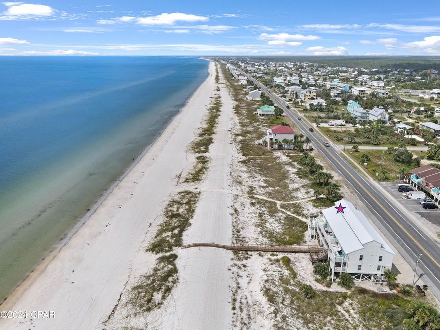 Are you dreaming of owning a stunning beachfront townhome at St Joe Beach? This end unit top floor gem features 2 bedrooms, 2.5 bathrooms, and breathtaking views of the Gulf of Mexico. As you step into the living room, you'll be greeted by panoramic gulf views that will take your breath away. The open area living, dining, and kitchen space is perfect for entertaining or simply relaxing by the fireplace. The kitchen boasts a beautiful kitchen island, stainless appliances, white cabinets, and quartz counters, creating a modern and elegant space to prepare meals. On the main floor, you'll find one of the master suites complete with a sitting area and a luxurious master bath featuring a double vanity and tub/shower. Upstairs, the second master bedroom and bath offer privacy and comfort, along with convenient access to the laundry area. This townhome is being sold fully furnished and equipped, making it move-in ready for you to start enjoying the beach life right away. Step out onto the back porch to soak in the stunning views of the Gulf of Mexico, with miles of beach waiting to be explored and unforgettable sunsets to be enjoyed. Located in Gulf County, this property offers pet-friendly beaches and is golf cart friendly, allowing you to fully embrace the coastal lifestyle. With no HOA fees this townhome presents a rare opportunity to own a slice of paradise at an incredible value. Buyer to honor rentals through 2024, making this property not only a dream home but also a lucrative investment. Don't miss out on this chance to own your own piece of paradise at St Joe Beach! No HOA.