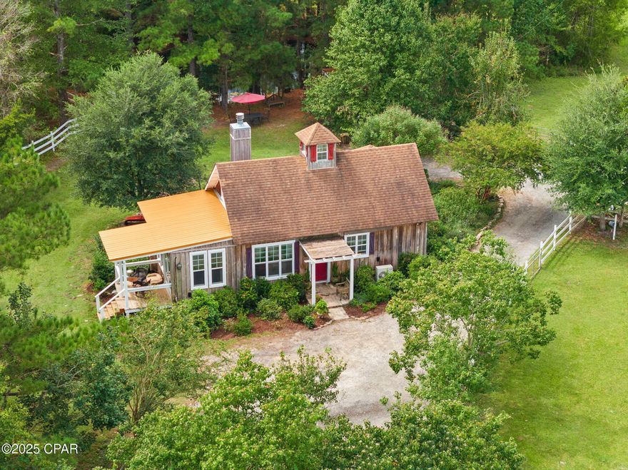 CURRENTLY UNDER CONTRACT, SELLER WILL CONSIDER BACKUP OFFERS' A RARE FIND — This unique 10-acre farm nestled in the scenic rolling hills of New Hope, offers a charming 1,400 sq. ft. custom-built home, two spring-fed stocked ponds, and an income-generating, turnkey 7-stall horse training and boarding facility with multiple barns and expansive, beautifully fenced pastures. There is a 475 sq. ft. paddock/tackroom apartment and a 720 sq. ft. building ready to become a mother-in-law suite/office/design studio. The 2016 two bedroom home exudes rustic European charm with board-and-batten cypress siding, exposed post-and-beam framing, soaring cathedral ceilings, roof cupola, French doors, wood and tile floors, 2 cozy fireplaces, 2 covered porches, 2 decks and a dock overlooking the serene ponds. Gated Entry with 750' asphalted driveway, 35 minutes from PCB. Additional features and accessory buildings include: 5 1/2 acres under fenced pasture, 3,300 ln. ft. 3-rails white horse fence. Main Barn is 720 sq ft offers 12 x 20 center isle, (3) 11x12 stalls, 11 x 12 feed-room. Access to 2.5 acre pasture. Paddock/tack-room building -offers (2) -12 x 12 stalls, 4 x 6 feed-room and a 470 sq.ft. tack-room/apartment. Workshop/storage shed- 192 sq.ft., 96 sq.ft. storage and 12 x 12 carport. Access to 2.5 acres pasture. Pony barn - 328 sq. ft. (2) 12 x12 stalls, Feed room 40 sq ft. access to .5 to 2.5 acre pasture. Design Studio/Mother-in-Law building/720 sq. ft. under roof, 480 sq. ft. dried-in, poured slab floors with additional nook for wood burning stove. Chicken house/storage is 300 sq. ft. Pump house is 64 sq.ft.- houses well pump, generator and extra storage. Multiple spaces invite ''homesteading'' with gardens and orchard potential, while mature pecan and fruit trees add natural beauty. This property is bordered by a 15-acre private residence, an 18-acre horse sanctuary, and thousands of acres of conservation land, offering unmatched privacy, peace, and an idyllic setting for your hobby farming, or country estate dreams. Bring your horses and enjoy a turnkey facility ready for boarding or training. Horses pictured are not included in the sale. Don't miss this opportunity. Call for viewing instructions.