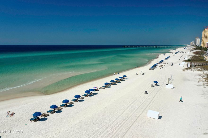 Walk out the back door right onto the beach.  This studio unit was adorably remodeled from top to bottom and would be perfect for your vacation home or to have as a rental.  The showpiece kitchen with all new stainless steel appliances (dishwasher was added that is not standard in these units), granite countertops, new cabinetry, breakfast bar and backsplash.  Additionally added were new grey wood look ceramic tile floors, new ceiling tiles and grids, new paint, new furniture,  all new light fixtures (recessed lighting and pendants over the bar), new ceiling fan, new blinds, shiplap on the walls, new AC mini split ductless unit (it is very quiet and up on the ceiling giving you more room in the room), new bathroom remodel with new tiled walk in shower and new vanity.  The room includes a King size bed, sleep sofa, dining table and two chairs, three bar stools, mounted television and outdoor table and chair set.  The kitchen is well stocked and rental ready.  Nicely decorated, you or your rental guests will find this an attractive unit to stay in. Covered parking is just outside from the unit.  Out back there is a tiled patio and a small grass area with sprinklers along with beautiful gulf views.  The small complex has a nice sized pool and a Bar & Grill to grab a quick bite to eat and a cocktail while enjoying the beach.  There are rental chairs and tents that can be purchased for the year or daily. There is a volleyball court in the sand for pick up games.  All utilities are paid for in the Condo Fees (electric, water, sewer, cable, trash and WiFi.) Resort Collection is the onsite property manager with their office open 24 hours.  The sellers only rented during the winter months keeping the rest of the year open for themselves, family and friends.  With so much to do nearby it's the perfect location.  Gulf World Marine Park is directly across the street, many restaurants such as Shuckums and Barefoot Grill are within walking distance and Pier Park with it's myriad of entertainment, shopping, dining and movie theater is less than half a mile away.  Don't miss taking a look at this one today!  For Financed Offers the lenders are requiring 30% down payment.  Ask for a list of lenders to use.