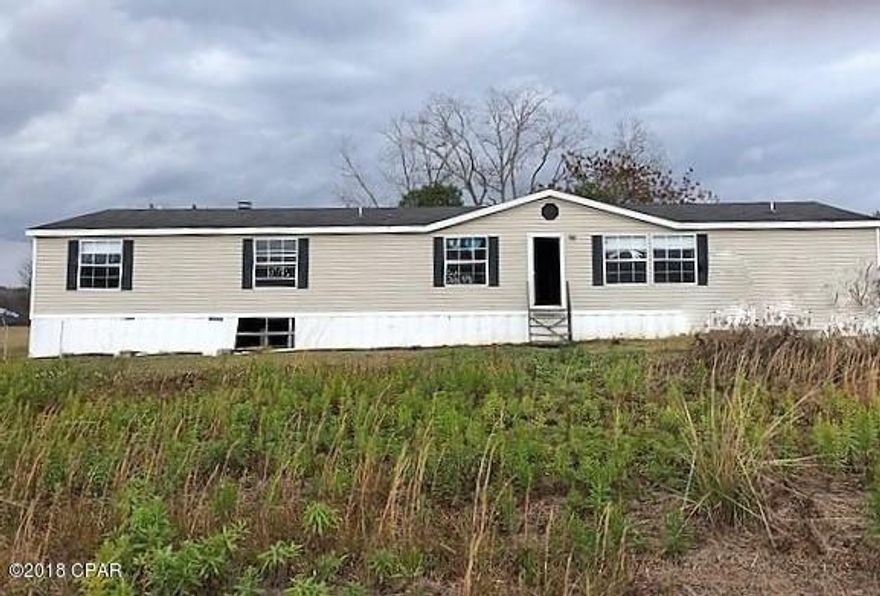 PRICE REDUCED!! This large doublewide sits on top of a hill with 2 acres of land.  You will need to do some renovations but it will be worth it!  It has 4 bedrooms, 3 bathrooms, a formal living room, a den with fireplace and a large kitchen with appliances.  It features a split bedroom design with large master bedroom that has it's own sitting room or would be great for a nursery.

Offers responded to within 24 to 48 hours.