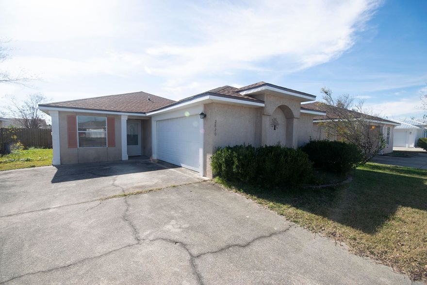 This gorgeous abode is move in ready today!  Centrally located, clean and VERY well maintained home with oversized garage and and privacy fenced back yard. Three bedrooms and two baths with an abundance of tile and just freshly painted. You'll appreciate the kitchen with breakfast bar and dining area that leads to a relaxed living area adjacent to sliding glass doors and back patio. There is also a separate living area in the front of home with plenty of room to entertain. Roof approx a year old, no interior hurricane damage and the irrigation system has a separate water meter.  Washer and Dryer are included in this sale... Call to view, you won't be disappointed, Seller is motivated!