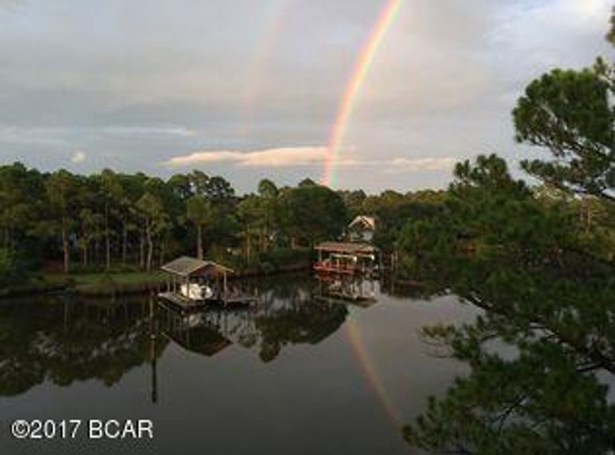 REDUCED FOR QUICK SALE.  WATER FRONT and walking distance to the beach, restaurants, shopping, and entertainment! Charming condo located on the North side of Thomas Dr. and nestled along Grand Lagoon which has gulf access. Community offers boathouse, boat slips, community pool, and clubhouse. This interior unit is on the third floor and is partially furnished. The condo is move-in-ready with fresh paint and carpet. A must see and easy to show!  Owner motivated and ready to sell.