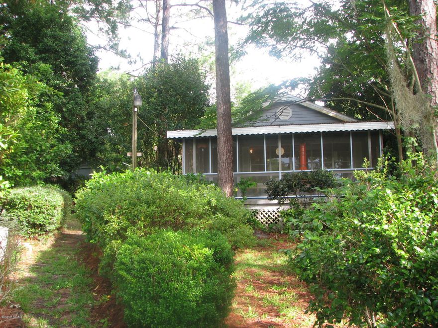 Weekend Getaway!! Waterfront on Black Lake, a natural deep swimming & fishing. Enjoy view from your screened porch or 30ft dock that extends out over the lake to a 13ft depth at the end. Yard is landscaped and contains a wide variety of flowering bushes and bearing blueberries, grapes, citrus fruit, fig and Japanese plum. Home is located on a newly paved road and is walking distance to Compass Lake in the Hills Lodge. Property is 2 miles from Hwy 231, which S to Panama City beaches & N to I-10 & Dothan, Al. This is a well cared for home. New Central H/AC unit just installed in Aug 2015. Property is fenced with chain link. Metal roof installed in 2010. Storage building, 2 car carport, owned propane tank, greenhouse, and all appliances will convey. 2 Bed/2 Bath w walk-in closet in Master.
