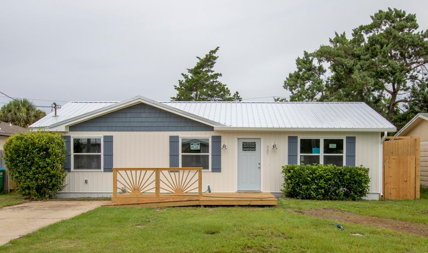 Perfect beach home has been completely remodeled, only a few minutes walk to beach! New metal roof, vinyl siding, windows, and all exterior doors including beautiful French doors opening onto the newly added rear deck. New front porch with step or ramp for easy access. This remodel includes all new sheetrock on all interior walls and has been freshly painted throughout. Plumbing upgraded throughout, including a newly installed tile shower in bath master bath, and tankless gas water heater.  The baths have new tile floors, vanities with cultured marble tops, custom-made vanity mirrors, lighting, and fixtures. Electrical upgrading throughout and includes smoke/CO2 alarms, LED lighting and ceiling fans in all 3 bedrooms and living room fan w/ remote. New appliances include refrigerator w/indoor ice and water dispenser, smooth top stove, microwave, dishwasher, and disposal. Custom kitchen cabinets w/ pullout pantry, granite countertop with deep stainless-steel sink and USB charging outlet.  Newly added square footage includes heated and cooled laundry room w/ connections for either electric or gas dryer, custom cabinets and folding counter.   Also installed new 8' fencing with 2 entry gates. Priced to sell!! *All sizes approximate, please verify accordingly.