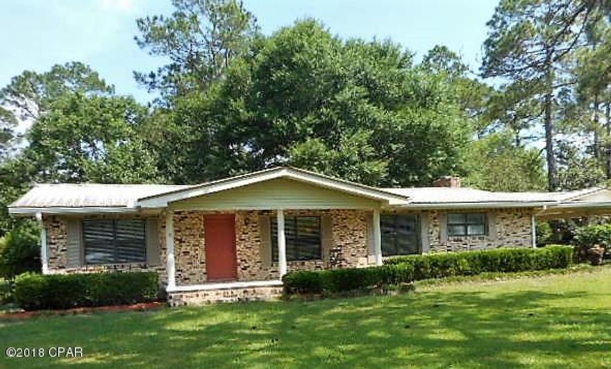 Spacious brick home fronting Hwy 90 in Ponce de Leon. This property has a bonus building fronting Hwy 90,used as a business. The main home has 3 bedrooms, 2 baths. The master bath recently updated and renovated with new fixtures, including two seat shower and tile floor. Hall bathroom has handicap compliant door. Large cozy great room holds kitchen, dining area and plenty of room for office desk. French doors and lots of windows bring the outside inside when you step into the tiled Florida room.Ideal spot for morning coffee or relaxing. Living room is spacious.Original hardwood floors in BR's beautifully refinished.Window blinds stay.Two central heat and air units. Metal roof. Extra large carport. Exit back door to enjoy sunshine on patio. RV connection with electric & water in back yard. Home has city water & septic tank. Storage building has a private well for watering garden or washing car. In addition to storage building, there is an older pole barn and a workshop with concrete floor behind house.  Detached 832 SF concrete block business building could be renovated to be used as an apartment rental, guest house, or as its present use.  It has two rooms, two half baths, covered front porch , newer metal roof, and highway frontage. The detached business building is on city water and city sewer.  This property has so much to offer. Nestled in the small town of Ponce de Leon away from the hustle and bustle of city life, yet only a short drive to shopping and beaches of south Walton and Panama City. Call for appointment to see this one today!