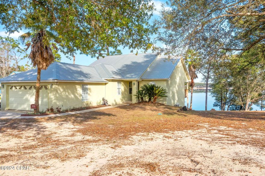 Immerse yourself in lakeside luxury with this stunning 5-bedroom, 3-bathroom house on Crystal Lake. Nestled amidst nature, this waterfront retreat offers a perfect blend of comfort and elegance. As you step inside, the main level welcomes you with a spacious living room, formal dining room, and a kitchen complete with a pantry and breakfast bar.  The abundance of natural light floods the space providing picturesque views of the lake from every angle. Revel in the warmth of the double-sided fireplace that graces both the master bedroom and the living room, creating an inviting ambiance. With three bedrooms and two bathrooms on the main level, including a master suite, this home is ideal for family living. Venture downstairs to discover a separate living space on the basement level, offering privacy with two additional bedrooms and a bathroom, perfect for guests adding versatility to your lakeside living experience. Step outside onto the wooded deck, where a serene walkway leads you to the water's edge. Enjoy the breathtaking views of Crystal Lake and soak in the tranquility of this waterfront paradise from your private dock with storage shed that invites you to indulge in fishing, water sports, or simply basking in the natural beauty that surrounds you. This property is not just a home; it's a lifestyle. Embrace the charm of lakeside living, where every day feels like a retreat.