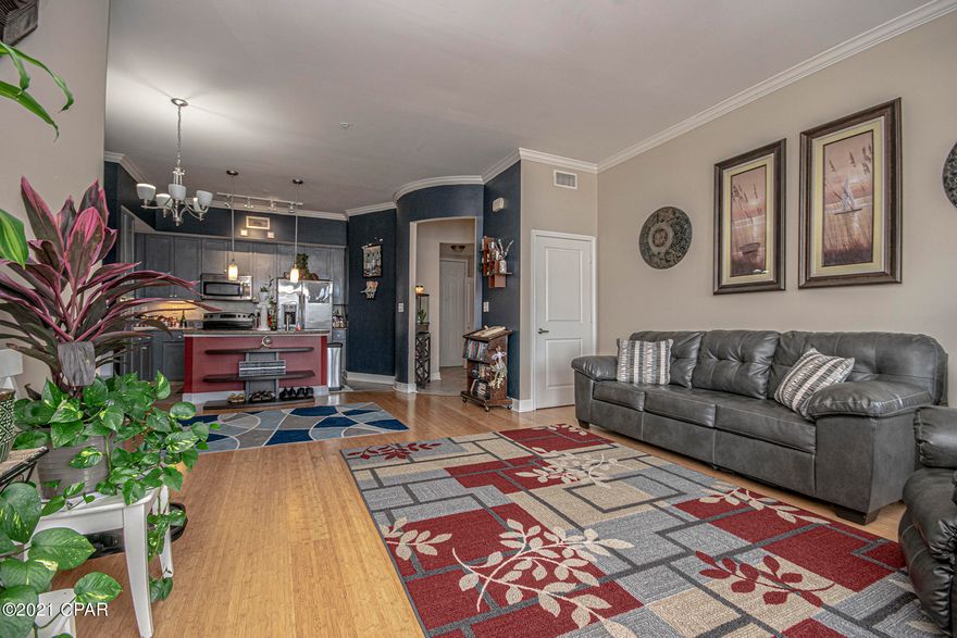 Beautiful condo living, just minutes from the white sandy beach. This top floor condo offers two master suites with spacious bathrooms as well as an additional half bath in the entryway for guests. Both master baths boast  walk in closets.  Kitchen features a granite countertop/bar, built in pantry cabinets, electric stove with overhead microwave. The kitchen opens up to the living room which features large windows, crown molding and 10 foot ceilings. The open floor plan allows the perfect atmosphere for entertaining. The large balcony may be accessed from the living room as well as both bedrooms for convenience. Outside on the property you will find a large pool, hot tub, basketball court and more! Call today and schedule your appointment to view this condo! Be sure to view virtual tour.