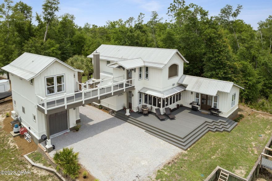 100 FEET of BOATABLE Waterfront on Deerpoint Lake!
This 3-bedroom, 2.5-bathroom home with additional 1-bed/1-bath Carriage house with mini kitchen offers views of Deerpoint Lake from nearly every indoor and outdoor living space. This is the one, The first of its kind, ''The Idea Home'', The Arthur Rutenberg home that inspired it all... The beginnings of Cedar Creek at Deerpoint Lake. If you are looking for space and privacy surrounded by nature and tranquility by the lakeside, you will feel right at home at 9734 Summer Creek Drive. 

Built on 1 acre of land, this Craftsman Style home celebrates the great outdoors through thoughtful window placements, a sizable covered front porch, and a Florida room that opens onto the large back deck. All living areas have wood flooring throughout, high ceilings, kitchen with custom cabinetry, farm sink, wine cooler, and a walk-in pantry concealed behind a barn door. 

After a long day you'll find the cozy living area with an inviting gas fireplace the perfect setting to wind down before moving on to the Main suite on the first floor that hosts spectacular views of the lake and French doors leading to the expansive deck.

Upstairs you will find 2 additional bedrooms, the crossover to the carriage house and an observation deck off the upstairs den that frames beautiful views of Deerpoint Lake.

The seller has recently replaced all decking on the outdoor living spaces including the porches and 330 ft of dock with Trex for longevity and low maintenance, most of the dock substructure has also been replaced. 

The interior walls have been professionally painted and all lights replaced with energy efficient LEDs. New 5 station sprinkler system on a deep well. This is a energy efficient home with spray foam insulation in the roof AND exterior walls. The flood Insurance policy for this home is $500/year, and the new owner can extend the dock or dredge for deep water access.
All measurements are deemed correct, buyers should verify if they are important.

Cedar Creek is gated subdivision that offers well thought amenities such as a fenced playground, community pool next to the ''Summer House'' a covered picnic area with accessible kitchen and built in Fireplace, and a unique Club house (Creek House) with high ceiling living room, fireplace, private room and catering kitchen. The Creek House is surrounded by porch sitting areas, an outdoor fireplace, raised viewing gazebo and a neighborhood pier.