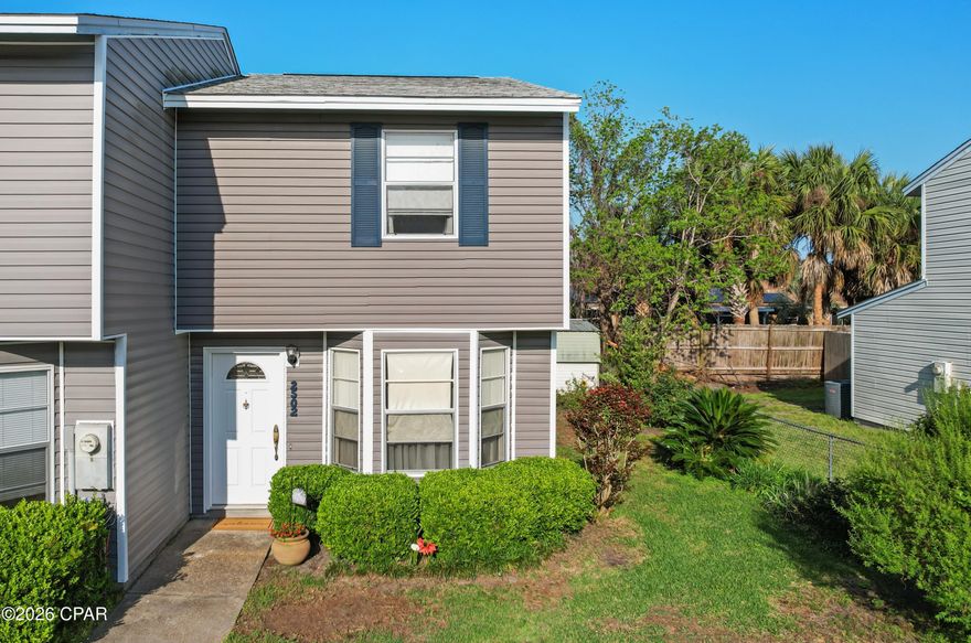 AFFORDABLE END-UNIT TOWNHOME IN LYNN HAVEN! The interior offers two spacious bedrooms and one full bathroom upstairs, along with a convenient half bath on the main level. The open-concept living, dining, and kitchen area creates a comfortable and functional layout, complemented by an interior laundry space.  Outside, enjoy a covered back porch, an outdoor storage room, a partially fenced backyard for added privacy, attractive landscaping, and an additional storage shed. Ideally situated in a central location, this home is within walking distance to dining, shopping, schools, and more. No HOA. Schedule your private showing today. Measurements are approximate.