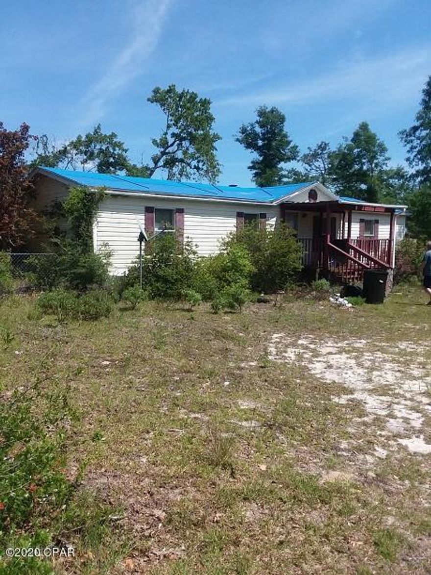 Almost an acre of land, older mobile home has no value and does not have a title. Only the land will transfer with sale, and buyers will be responsible to remove any unwanted structures.