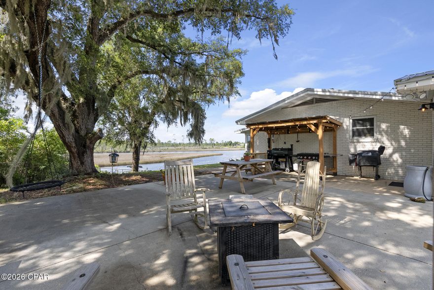 Rare opportunity to own a beautifully updated 3-bedroom, 2-bath brick home with Gulf access, situated on 5 private acres along Cook's Bayou. This property offers exceptional flexibility--bring the boat, RV, four-wheeler, or horse--with room to live, work, and play in a peaceful waterfront setting.

Built in 1976 and thoughtfully renovated, the 1,767 sq ft home blends classic character with modern upgrades. Interior features include functional wood burning fireplace, fresh paint, quartz countertops, new ceiling fans, and closet organizers throughout. The primary bathroom has been fully remodeled, and the kitchen is equipped with an induction cooktop, double ovens with convection and air-fryer modes, and stainless steel appliances--all less than three years old.

Significant improvements include popcorn ceiling removal, 2024 HVAC, Honeywell programmable thermostat, Pristine Air UV filtration system, water softener, generator outlet, 2017 metal roof, hurricane ties for wind mitigation, and a whitewashed brick exterior.

Outdoor amenities include a solar-powered gated entrance, 12'x32' shed, motorized screened back porch, raised metal garden beds, citrus trees, private pond, and mature moss-draped oak trees. Nearly $30,000 in dock upgrades include an expanded dock and 7,000-lb boat lift, providing direct access to the Gulf.

Property sits on tidal waters with Gulf access through Cook's Bayou. Bridge vertical clearance is approximately 9'6'', suitable for smaller boats. 

Ideal for a private waterfront homestead, recreational retreat, or future expansion--this unique property offers space, privacy, and true Florida waterfront living.