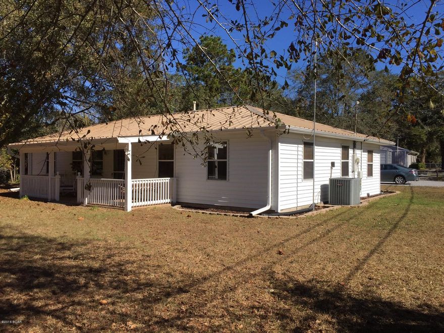 Waterfront property! This low maintenance home is on a creek that crosses under Hwy 231, feeds into Bayou George Creek and winds to Deer Point Lake. Much of the home has been remodeled and is in move-in condition. No carpet, just tile and high quality laminate hardwoods. The white kitchen features a new gas stove, new counter tops, new tile backsplash, new water heater and glass front cabinets up top. What was two bedrooms is now a 23x12 master bedroom. Most of the home has fresh interior paint, light fixtures and crown molding. The 27x10 sunroom also serves as an entertainment area and leads to an shaded open deck overlooking the creek. AC unit replaced in 2010, metal roof three years old. The carport/storage building is 22x40 and there is a separate 10x12 metal storage building.