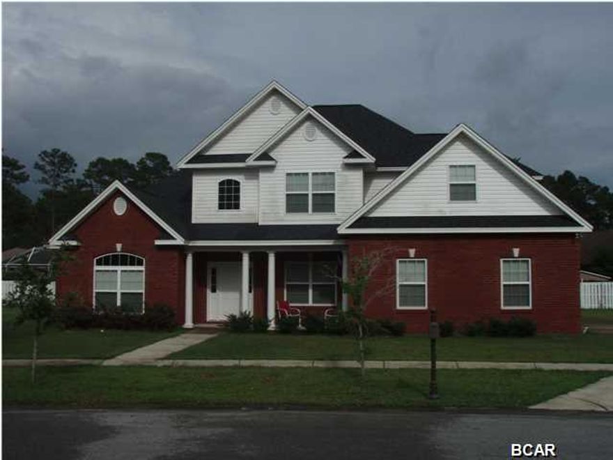 All measurements and information are approximate. Wonderful, spacious home on a cozy cul-de-sac in the beautiful community of Wood Run in Lynn Haven. Tons of upgrades like countertops, stainless appliances, 9'&10' ceilings (some vaulted) cabinets, flooring, etc. Attractive red brick exterior with white trim, columns and second floor siding. Front porch is covered and friendly. The garage has side entry with door leading to the laundry area first then the kitchen. Kitchen is open and inviting with a half bath, open dining area and fabulous entertaining possibilities with open living area including a lovely fireplace accent. The master suite is downstairs with vaulted ceilings, roomy closet and large bathroom with tub, separate shower and private toilet. A bonus room on the first