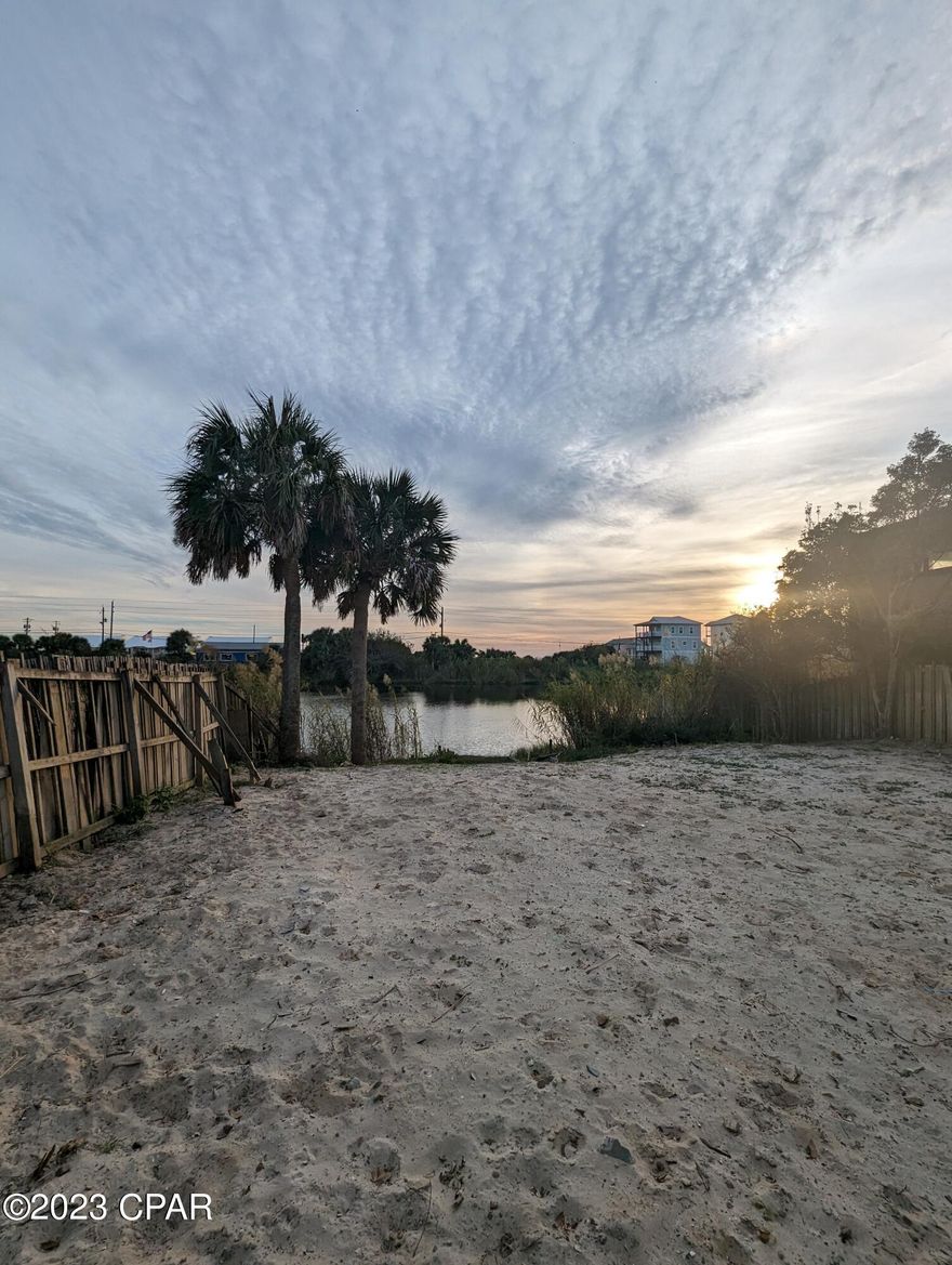 'CURRENTLY UNDER CONTRACT, SELLER WILL CONSIDER BACKUP OFFERS' -Discover this prime R-2 zoned property on a  serene lakefront cul-de-sac, offering panoramic Gulf views. With the potential for up to a 45' building height, this lot presents versatile possibilities. A land bridge leads to nearby Public Beach Access 77, and sewer access is conveniently close by. Create your dream oasis or vacation rental(s) in the tranquil lakefront setting. If important, it is the responsibility of the buyer or buyer's agent to verify measurements and/or details.
