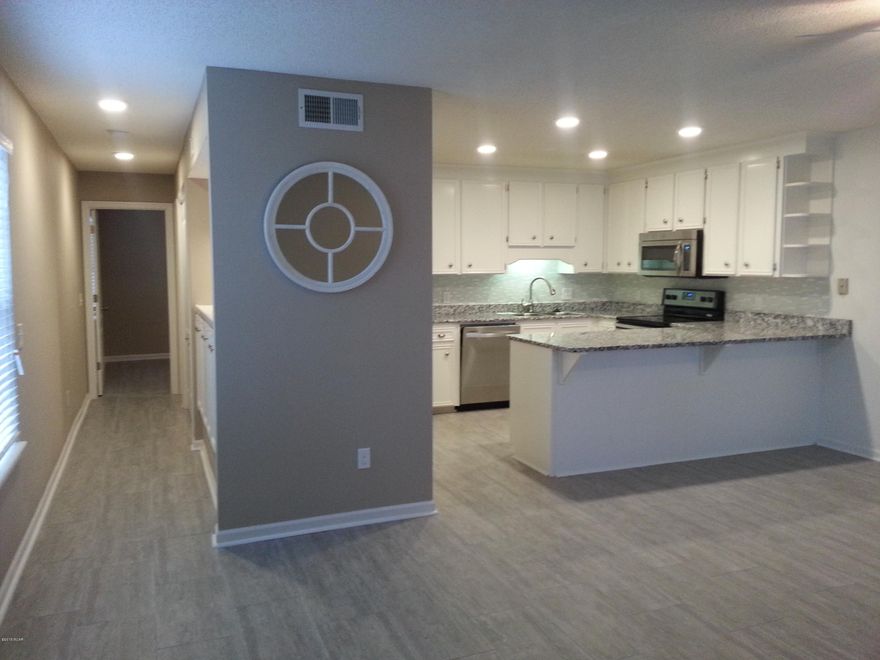 Spectacular renovation! Brand new granite counter tops, stainless steel appliances, brushed nickel hardware,

glass tile back splash,wood grain tile flooring through out, new HVAC system, water heater, front loading washer/dryer, front storm door,and ceiling fans and fixtures! This ground floor, one bedroom condo features a large open living/dining/ kitchen area, bunk and storage in the hall. Large master bedroom with Jack & Jill bathroom and covered patio out your front door. The gated community of Horizon South offers many amenities including 4 Pools, Kiddie Pool, Jacuzzi Spa, Shuffleboard, Basketball, Tennis, Miniature Golf Course, Club House and just a short stroll to the beach! Complex is only minutes to Pier Park for shopping, restaurants or entertainment. This would be a wonderful full time home, vacation home or investment property!