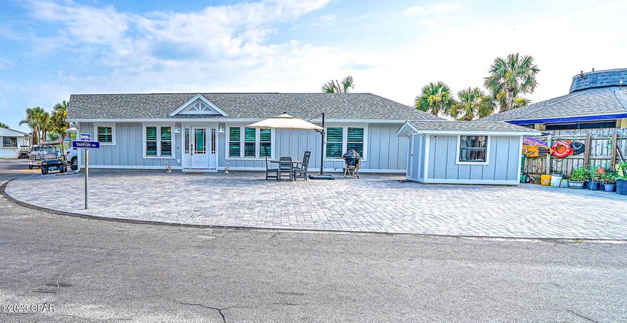 Check out this stunning 3 bedroom, 2 bath site-built home on a permanent foundation that includes an extra lot. The extra lot gives you that amazing outdoor space making entertaining fabulous and the possibilities endless.  The floor plan of this home is super open and flows very well.  The large kitchen has a great breakfast bar and is open to the living room.  Seller has spared no expense by adding new siding, hurricane rated windows, amazing new pavers, plantation shutters and much more.  Keep your boat or RV at your own beach house... don't miss out on this exceptional opportunity to have everything at your fingertips... your boat, your RV or build your outdoor kitchen with pavilion that you have been dreaming of... It doesn't get better than this! Venture Out is a golf cart community that has 300' on the beautiful pristine beaches of the Gulf of Mexico and 1,000' on the Grand Lagoon. Venture Out has something for everyone. With two pools, fishing pier, boat ramp, mini golf, children's playground and much more!