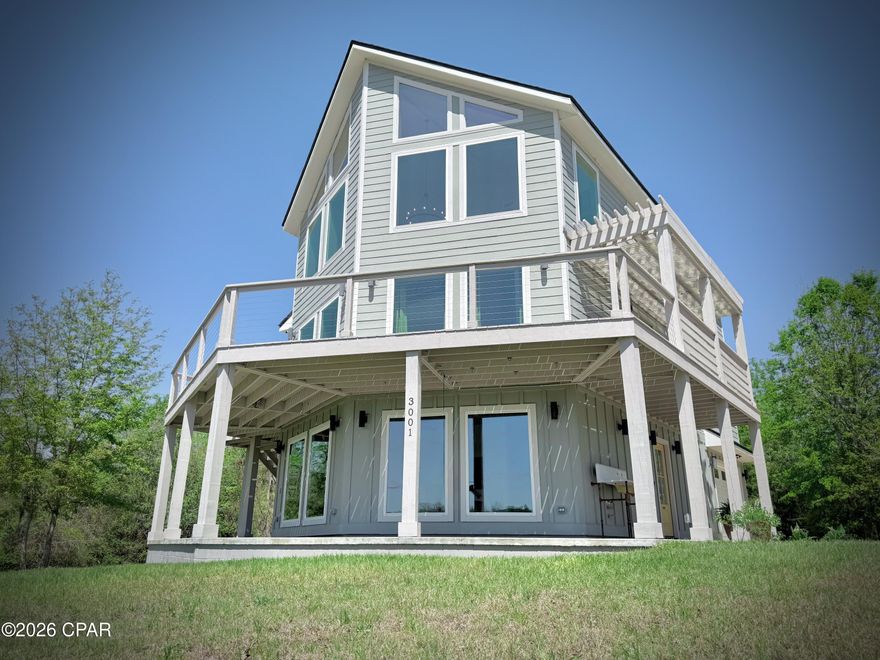 RARE FIND ! Custom-Built 2023 home, offered for the first time. Set on 1.24 acres along a private dead end road, this thoughtfully designed three-story residence offers panoramic Millpond views and a level of craftsmanship rarely found in the Marianna area. The home features 4 bedrooms, 3 full baths and two dedicated offices with elevated views,  ideal for remote work or hobbies.- The first floor includes a private guest quarters with separate entrance, living space, and plumbing/wiring in place for future kitchenette, making it suitable for family or guest.
Built for efficiency and comfort, the home includes spray foam insulation, Low E windows and 3 separate HVAC systems..Interior finishes include custom cabinetry and woodwork, granite countertops and oversized kitchen island offering ample storage and seating. Outside, you have an approximate 1200+ SF wrap-around covered patio and deck for your outdoor pleasure.
CALL for your appointment today to see the Immaculate home !