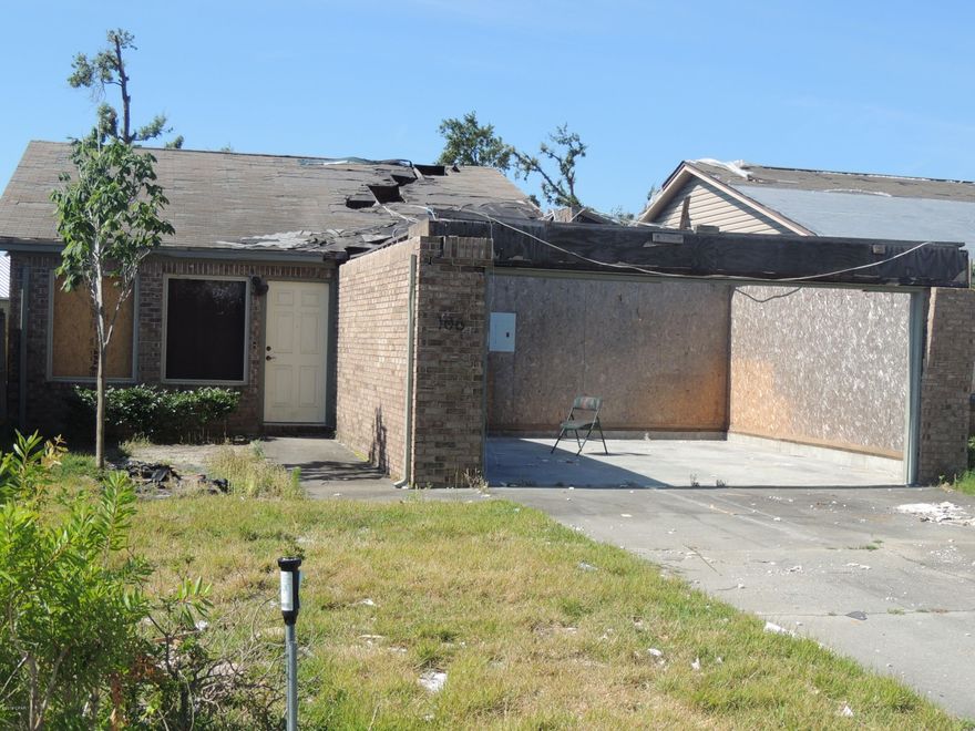 Age, sq ft, lot and room sizes are approximate.  This house has had damage from Michael, needs roof, trusses over garage, interior done.  All sheetrock etc has been removed.   Duct work, electrical and plumbing still there. Needs two front windows, all others windows seem to be good.  Cleared Structural engineer's letter in file.  Great location in a ''NO'' flood zone lot.  HOA cuts front yard and each owner has access to private  dock and lake Marin. Don't miss this opportunity!