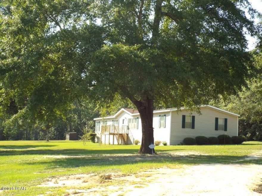 Large four bedroom two bathroom manufactured home on 5 acres just a short distance form a paved road offered as is.   The property lot is mostly cleared, ahs a an 8x10 Shed for your storage needs and the house is all electric.  All sizes area approximate please verify accordingly.