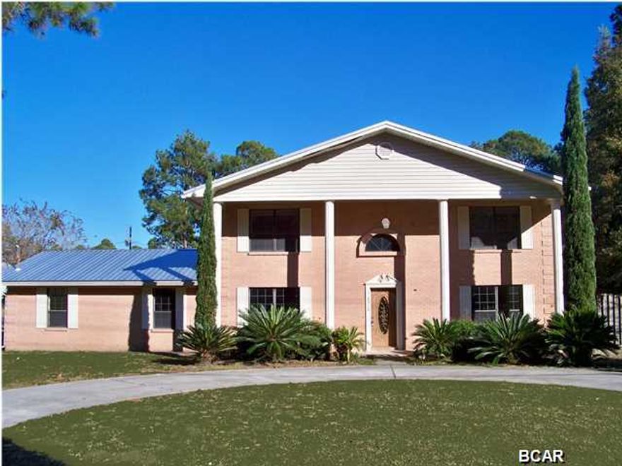 New Roof & Carpet: LARGE 4 bedroom 3 bath Colonial-style 2-story home complete with 4 massive front columns. This home has a formal living room, formal dining room, kitchen with breakfast bar & breakfast/dining area, a huge Florida room a den/family room with enormous stone hearth/gas fireplace, and a separate office with oak desk and shelving. The garage was enclosed to make a large bonus room with its own adjacent bedroom & bath. It also has a private entrance & its own separate A/C unit. The backyard has a yard building and is partially privacy fenced. Plenty of parking with a widened side entrance driveway AND a circular drive off State Ave. Convenient to everything on 23rd Street-shopping, restaurants, doctors' offices etc. This is a Fannie Mae HomePath Property. CALL A REALTOR