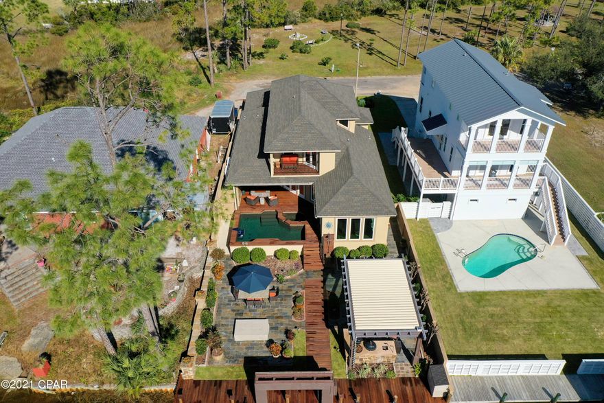 Exceptional waterfront home completely renovated in 2020: all new everything, windows, doors, roof, plumbing, electrical, flooring, insulations. The exterior includes many features, including a boat lift, floating dock for sea-doos, heated pool and spa, large gas fireplace, pergola with automated shutters and screens over the cooking area and pool deck, landscaping, automated lighting, and sound. The dock, walkways, and pool area were built out of EPI wood.  The home's interior has the latest Ductless HVAC system by Mitsubishi and Lutron smart switches that work with Alexa. The kitchen includes new top-of-the-line appliances, including Wolf 48'' gas/electric range, Sub-Zero refrigeration, and Miele built-in coffee system and steamer. The kitchen countertops, island, and walls are... porcelain.  There are speakers throughout the house for music and tv using Control 4 and 12 speakers for the home theater. In addition, the house is wired for security and lighting. Other notable new features to the remodel include closed-cell foam insulation for the entire house, including the heated and cooled garage. There is a whole house water filtration system and gas tankless water heater.  The engineered raised floor system is also insulated and encapsulated with a sizeable dehumidifying system. The master bathroom includes a built-in sauna. Not one feature was overlooked or omitted from this fabulous waterfront home. Call for more details and a private showing that will make you want to call this Your home!