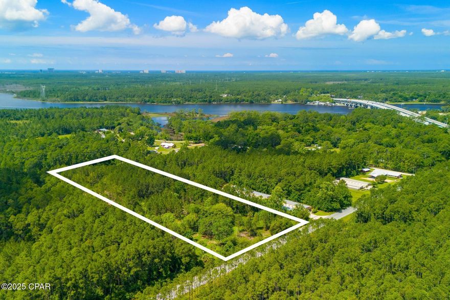 Discover an incredible opportunity with this 8-acre property located in one of the most rapidly growing areas of Panama City Beach. Zoned WBC (West Bay Center) within the West Bay Sector Plan, this property offers exceptional flexibility for a wide range of development possibilities. At the rear of the property lies a picturesque pond, an ideal focal point for a future community amenity or serene natural retreat. Strategically positioned, this property is just two miles from the bustling Northwest Florida Beaches International Airport and one mile from thriving Latitude Margaritaville Watersound, a vibrant 55+ community poised for significant expansion. Its proximity to the newly established Tallahassee Memorial Healthcare Hospital and a growing commercial hub enhances its appeal. Adjacent to the upscale RiverCamps on Crooked Creek, the property benefits from a tranquil and desirable neighboring community. Utilities, including water and sewer, are conveniently located nearby, providing the essential infrastructure and flexibility for a visionary development. Whether you're envisioning a residential enclave or exploring the possibilities of commercial ventures, this prime acreage combines natural beauty, a strategic location and limitless potential to bring your vision to life.