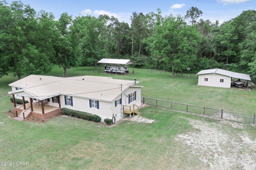 Well Maintained....Four Bedroom, Two Bath Mobile home sitting on over 4 acres. Home features formal living, den with wood burning fireplace. Master bedroom with his and her walk in closets, updated master bath with raised double vanities with shower unit. Kitchen is open to den area. Utility room has room for freezer.  Ac unit is just few years old...metal room. Covered front porch, 10x26 covered back porch. Covered Rv storage, Large barn both have water and electric. Backyard has chain link fenced. And so much more!