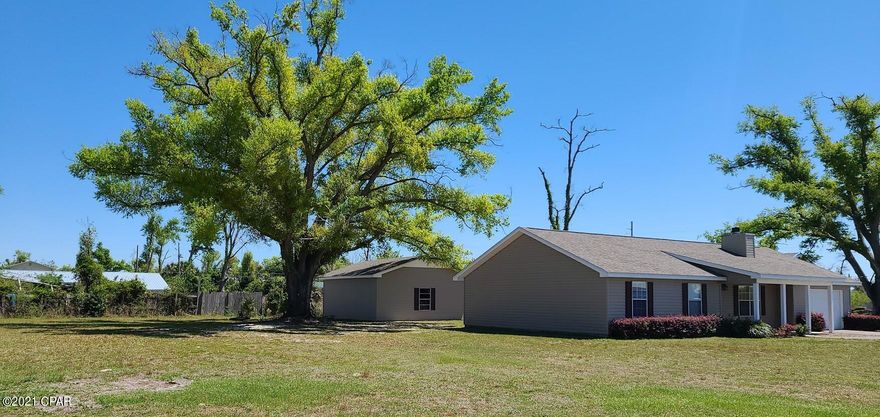 Check out this 3bd/2bth home with large 24 x 30 workshop PLUS the property includes the adjacent vacant lot next door (75x150) that is already tapped for city sewer/water. This charming home offers a new roof, new vinyl flooring & exterior siding. The kitchen offers plenty of cabinetry for storage with large kitchen island. Oversized laundry room features a built-in ironing board & utility sink. The guest bathroom has been updated with jetted tub & pedestal sink. The master bedroom offers ensuite bathroom & large walk-in closet. Enjoy the afternoons in the screened-in back patio. Oversized attached single car garage also has pull down stairs for attic access. Items in the workshop do not convey. All sizes/measurements are approximate; please verify if important!