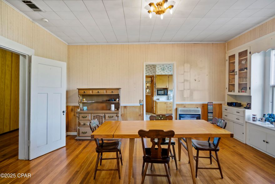 Apalachicola River landing 0.6 mi • Near Downtown Blountstown • Screened front porch • Covered back porch • Detached carport • 0.79 acre lot • Built 1925

Set on a wide 0.79 acre lot, this 1925 home at 16090 SE South Pear Street blends historic character with practical living space across 2,105 square feet. The layout includes four bedrooms, two baths, a screened front porch, and a covered back porch that steps out to a backyard shed and open yard area. Inside, the home offers a dedicated laundry and storage room at the rear, additional storage at the front, and stair access to an attic that can serve as flexible space for storage or future use. Systems updates include electrical rewiring completed in 1984, a roof from 1990, AC from 1997, gas heat in the bedrooms, and a hot water heater installed in 2022. The property also features a driveway and detached carport for parking. Appliances convey with the sale. The location places you approximately 0.6 miles from the Apalachicola River landing and close to the shops, dining, and services of Downtown Blountstown.