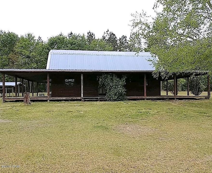 Custom-Built, 2-Story Home located in a peaceful, quiet setting just north of Bonifay, Florida.  Follow your private driveway back to 29.95 acres of beautiful, unrestricted paradise.  Sit on your wrap-around porch and enjoy the scenery and the sunsets.  First floor consists of a huge living room, a large kitchen, one bedroom and one bathroom.  The entire second floor consists of the master bedroom and bathroom and also has two built-in bunkbeds, or daybeds.  Large, separate laundry room with a sink and toilet.  Attached 1-car carport located on back of house for easy entrance.  Huge, deluxe barn with concrete flooring, oversized garage door and concrete entrance.  Land is fenced and cross-fenced and is ready for cattle or horses.  Has a chicken coop and rabbit hutch.