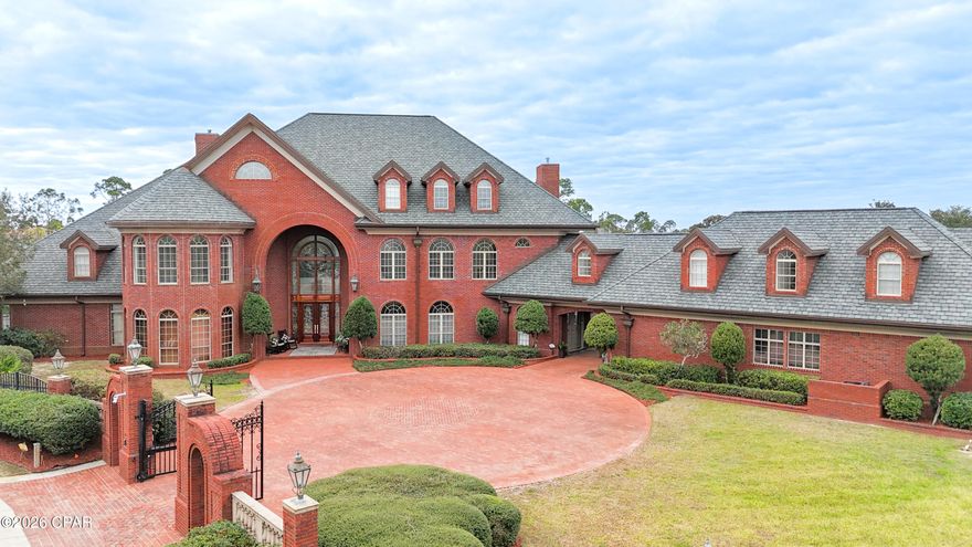 3703 Preserve Bay Blvd | Estate Living in The Preserve

Located within the prestigious gated community of The Preserve, this extraordinary 12,200 sq. ft. estate sits on approximately 1.6 acres and offers a rare opportunity to own one of Bay County's most remarkable homes. Combining impressive architectural scale with timeless craftsmanship, this property was designed for both elegant living and exceptional entertaining.

From the moment you arrive through the gated brick entrance and circular drive, the home makes a lasting impression. The grand brick façade, dramatic arched entryway, and classic dormer windows create a striking presence that reflects the quality and attention to detail found throughout the property.

Inside, the home showcases Italian marble, Brazilian mahogany hardwood flooring, and premium granite and marble finishes that add warmth and sophistication throughout the living spaces. Soaring 11-foot coffered ceilings and 8-foot interior doors create an atmosphere of openness and light, while lead crystal chandeliers and detailed woodwork provide a timeless elegance.

Designed with both comfort and recreation in mind, the property offers an impressive collection of amenities that support an active lifestyle. The grounds feature private tennis, basketball, and volleyball courts, along with a fitness room, ballet/yoga studio, and an expansive game room.

For entertainment, the home also includes a custom media and music room located within the third-story dormer, where you can enjoy beautiful views toward the bay while hosting family and friends.

The outdoor spaces create a true resort-style setting, centered around an oversized saltwater pool and spa surrounded by beautifully maintained grounds that provide privacy and room to enjoy the full 1.6-acre estate. The pool area has been recently upgraded with a commercial-grade pump and salinator system installed in 2023, along with new safety railings.

Over $300,000 in recent upgrades provide exceptional efficiency and peace of mind, including whole-home Caterpillar generators for complete power independence, three new HVAC systems, six new water heaters, and a durable 50-year roof. A pneumatic elevator also provides convenient access between levels of the home.

The estate offers six spacious bedrooms, each with its own private ensuite bath, along with 11 bathrooms thoughtfully positioned throughout the home, providing comfort and privacy for both residents and guests. A four-car garage offers additional space for vehicles and storage.

3703 Preserve Bay Blvd is more than a home, it is a private estate in one of Bay County's most desirable communities, offering a lifestyle defined by space, craftsmanship, and exceptional amenities.