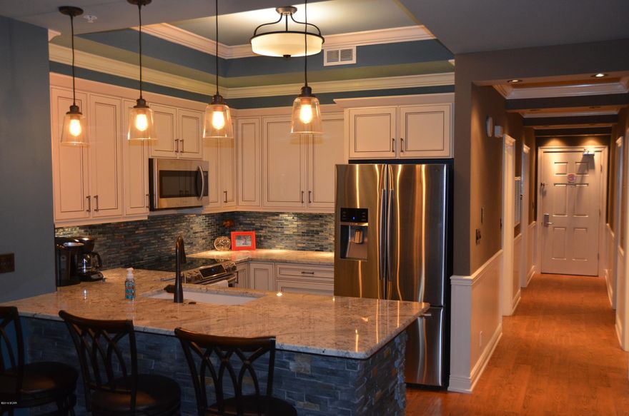 'One of a kind' at Calypso Towers. Converted 3BR's & 2 BA's. This condo has been completely renovated in 2016 with some awesome new ideals. Upgrades include: New Kitchen with stainless steel appliances, granite c-tops, glass backsplash, natural stack stone, trey ceiling, custom lighting, cast iron sink. Everything was addressed in great detail. New Cast Iron Wet Bar. Crown molding, chair railing & wainscoting added. Nice Touch! Very unique creativity. Added closet for 3rd BR, now have 2 owners closets, plus linen closet. Custom design 'Barn Doors' in front BR's, save space, matches headboard. A lot of effort & care when into designing this family condo. Recessed Blind Panels w/ Columns. All New Furnishings, New Flat TV's.  New Washer/Dryer, New Geo Spring Hot Water Heater. FRESH & NEW !!!