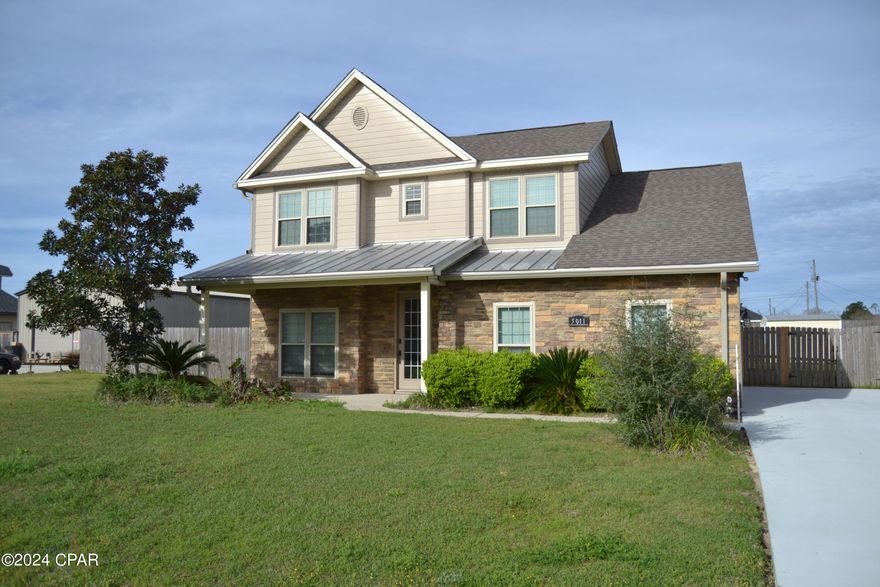 Introducing 5011 Maggie Lane to the market!!!  This home features 3 bedrooms, 2.5 baths and sits on one of the largest lots (100x130) in the neighborhood.  Plenty of room in the back yard to park a boat or RV and still have room for a pool.  The interior of the home centers around the great room/eat in kitchen.   The custom wood cabinets look amazing with the white quartz counter tops and stainless appliances.  A kitchen island creates more space for the gourmet chef. Wood plank style ceramic tile covers the floors in the kitchen, great room, baths, entryway and the bonus den/office off the front entrance.   The master bedroom is located on the first floor and features a luxurious bath with double quartz topped vanities, garden tub, private commode and separate shower. There is also a custom shelved walk in closet in the master.   The laundry room and half bath are just off of the garage entry near the kitchen.  Upstairs there are 2 large  bedrooms with big closets and wall to wall carpeting AND a full bath.  There is also attic storage that is easily accessible.   Off the back of the home is a screened in patio.  The 2 car side entry garage takes care of car storage as well as the freshly poured concrete driveway that leads to back yard access.  The exterior of the home is maintenance free hardie plank and stone.  The back yard is completely fenced and features a large storage shed.  The home has natural gas that powers the gas stove and on demand water heater for great energy efficiency. The sidewalk was recently redone with fresh concrete. This neighborhood has NO HOA and is close to schools, shopping and Tyndall AFB. Call today to see this one.