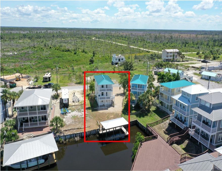 Canal Front Home in Mexico Beach – this is the only single family home with a private boat slip on the market in Mexico Beach. It's priced to sell with vacant lots that allow a boat slip currently starting at $285K. Short walk to the beach compared to most canal front homes and no HOA fees. Setup for boating and fishing with a great storage garage for all of your gear and a downstairs suite that can be separated from the top two floors. New Hardi siding and a number of upgrades will be found including a completely redone middle/living floor with new core-tec flooring, cabinets, stainless appliances, quartz countertops, and more. Broker is part owner. Reasonable insurance and in the X/.02 flood zone.