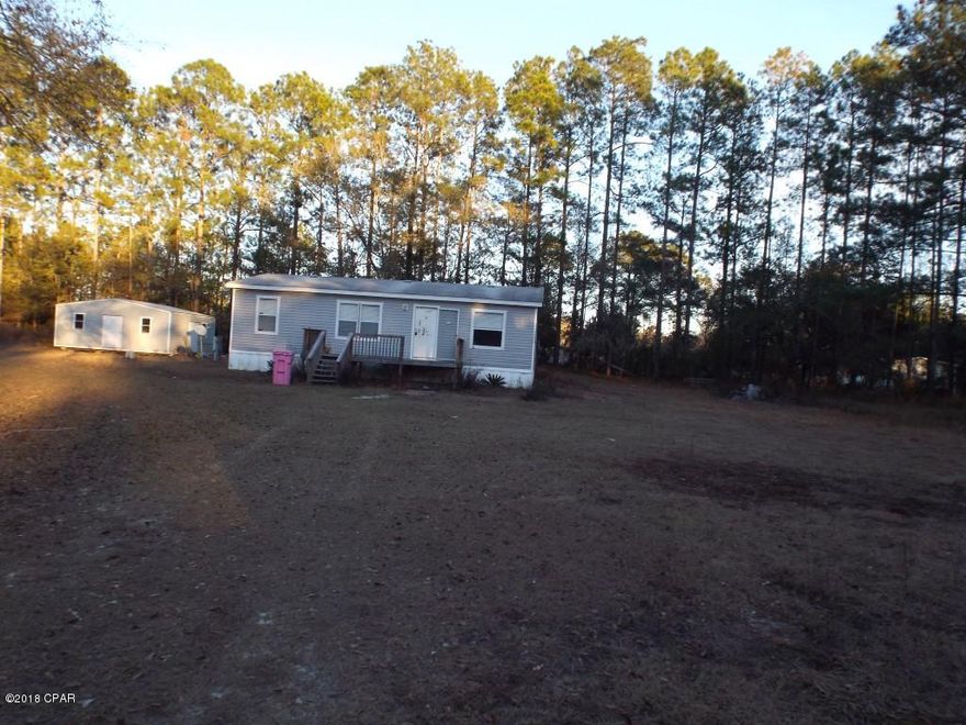 Thee bedroom two bathroom manufactured home on  a county maintained road on an acre lot offered as is.  The lot has two separate septic tanks and a large (20x24) work shop shed.  All sizes are approximate or taken from other sources please verify accordingly.