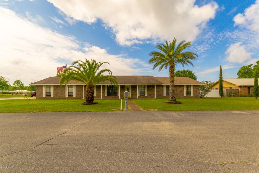 Spacious 4 bedroom 2 bath home located on a corner lot, close to Tyndall AFB. The driveway has full RV/MotorHome hook up (water, sewage & 120V 30A power). Gorgeous mosaic tile designs in the foyer, family room and above the tile fire place, wood flooring in large main living room, tile throughout the kitchen/breakfast/mudroom/formal dining/and sitting area. Open kitchen has stainless steel appliances and ample cabinetry. Formal dining/sitting area/den has a gorgeous tiled fireplace. The large master bedroom has his and her closets and doors leading to private patio. Spacious bedrooms and guest bathroom with dual vanities. Oversized garage with workshop area, sprinkler system, above ground pool, exterior deck and workshop/bar/mancave! All new A/C in 2014, irrigation well pump 2018.